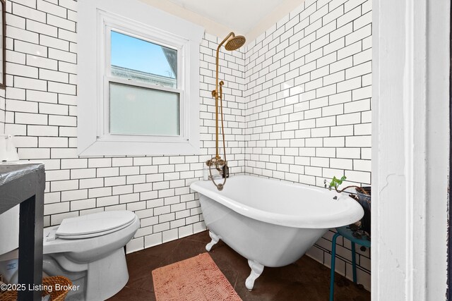 full bathroom featuring tile patterned floors, toilet, tile walls, a freestanding bath, and walk in shower