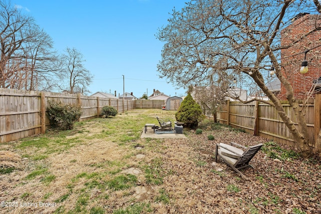 view of yard with a fenced backyard, a shed, and an outdoor structure