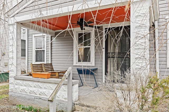 view of exterior entry with ceiling fan