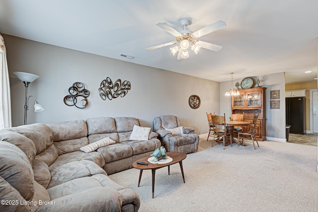 living area with a ceiling fan, light colored carpet, visible vents, and baseboards