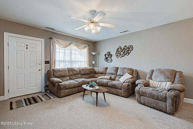 living room featuring visible vents, ceiling fan, baseboards, and carpet