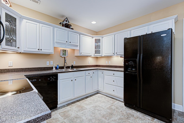 kitchen featuring black appliances, glass insert cabinets, recessed lighting, white cabinetry, and a sink