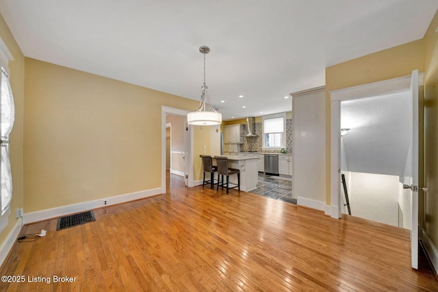 unfurnished living room with recessed lighting, visible vents, baseboards, and light wood-style flooring