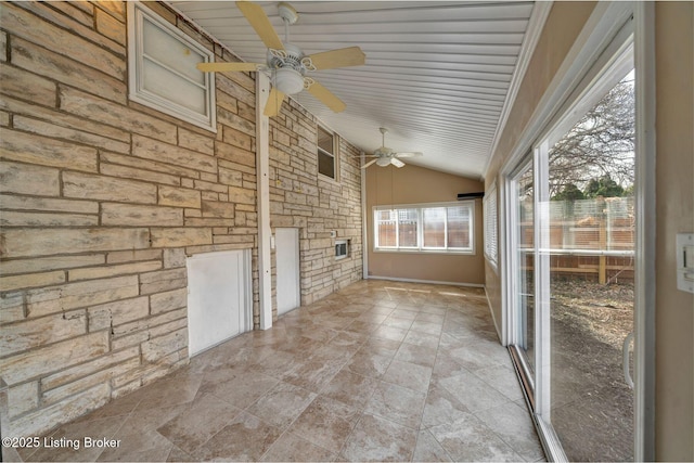 unfurnished sunroom with vaulted ceiling and ceiling fan