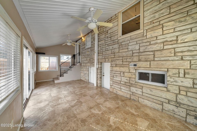 unfurnished living room with stairs, lofted ceiling, and ceiling fan