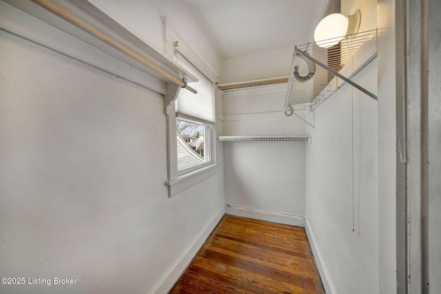 walk in closet with wood finished floors