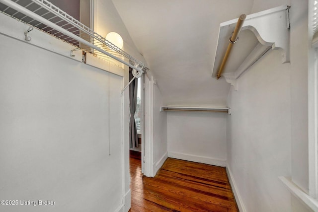 spacious closet with lofted ceiling and wood finished floors