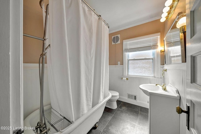 full bath with vanity, visible vents, ornamental molding, wainscoting, and curtained shower