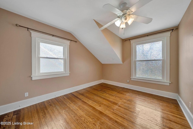 bonus room featuring plenty of natural light, baseboards, and hardwood / wood-style floors