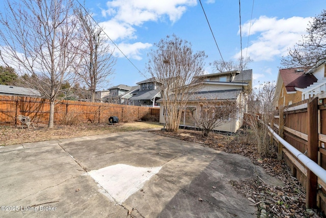 view of yard with a patio area, an outdoor structure, and a fenced backyard