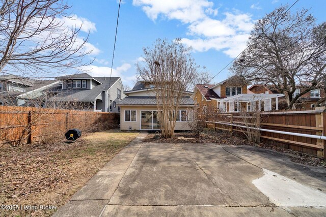 view of front of property featuring a patio and fence private yard