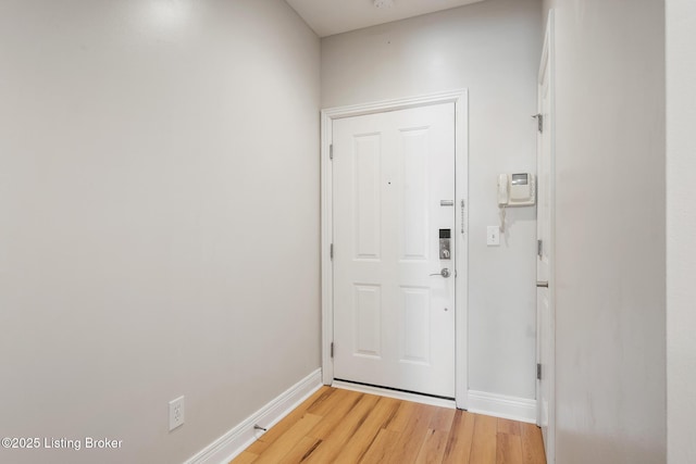 entryway with light wood-style floors and baseboards