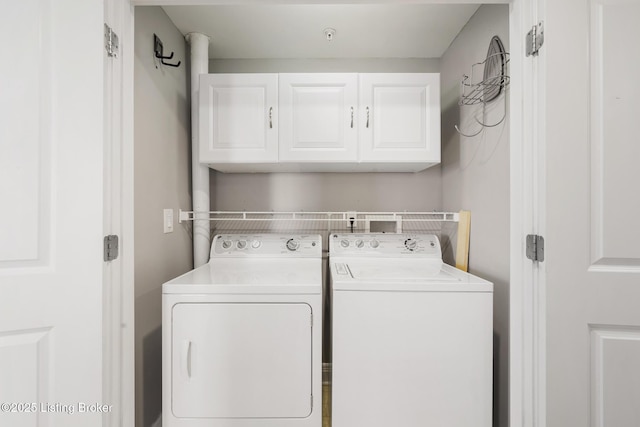 laundry room featuring washing machine and dryer and cabinet space