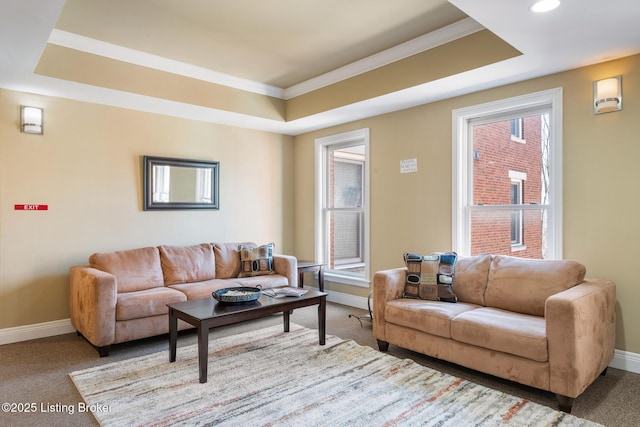 carpeted living area with recessed lighting, baseboards, and a raised ceiling