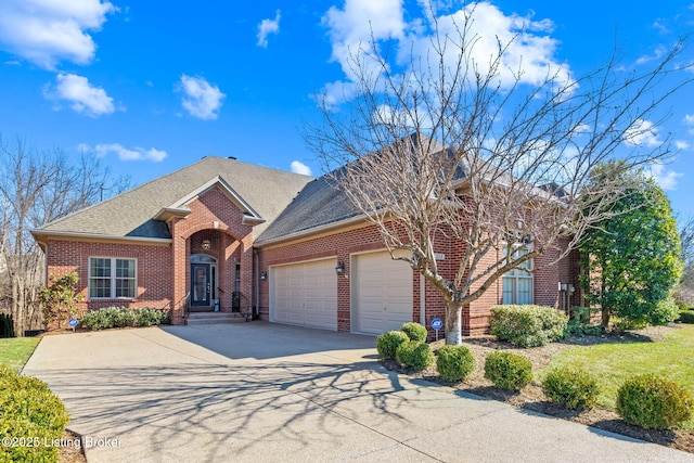 view of front of home featuring brick siding, an attached garage, and driveway