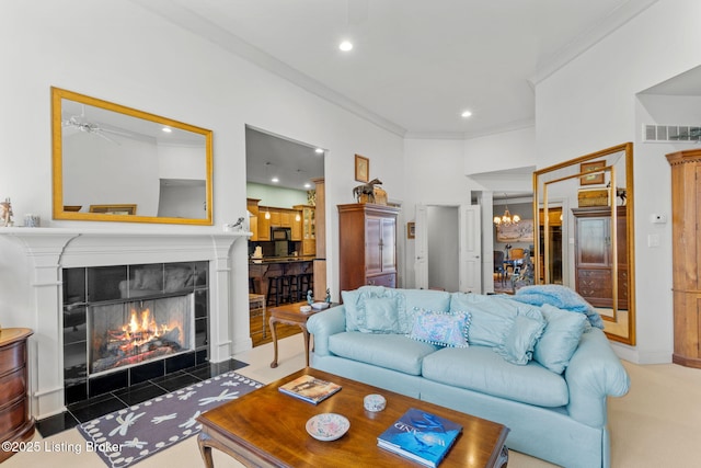 carpeted living room featuring visible vents, ornamental molding, recessed lighting, a fireplace, and an inviting chandelier