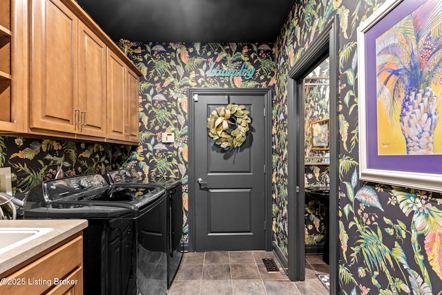 washroom featuring wallpapered walls, tile patterned floors, cabinet space, and washing machine and clothes dryer