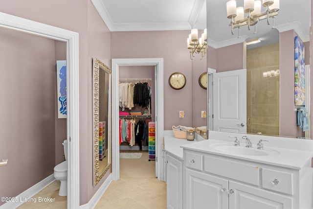 bathroom featuring a spacious closet, baseboards, toilet, ornamental molding, and vanity