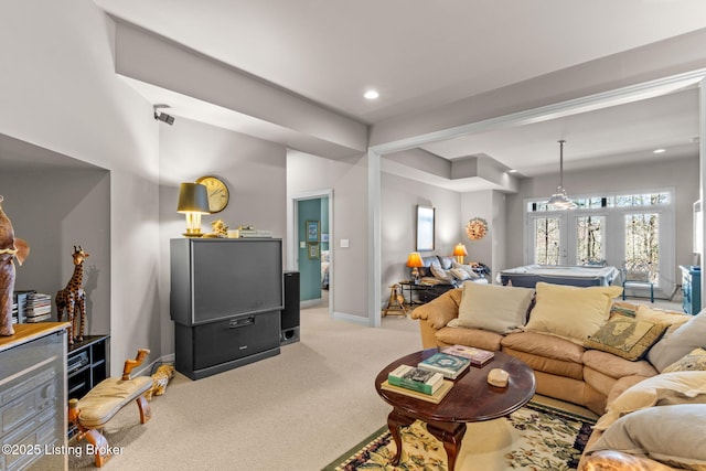 living area featuring recessed lighting, french doors, baseboards, and light carpet