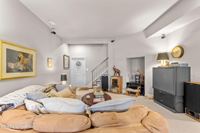 carpeted living area with stairway