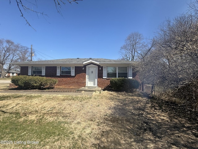 single story home with a front lawn and brick siding