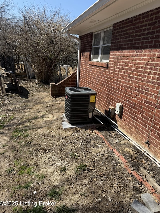 exterior space featuring brick siding and central air condition unit