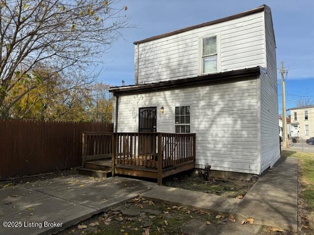 rear view of property with a patio area, a deck, and fence