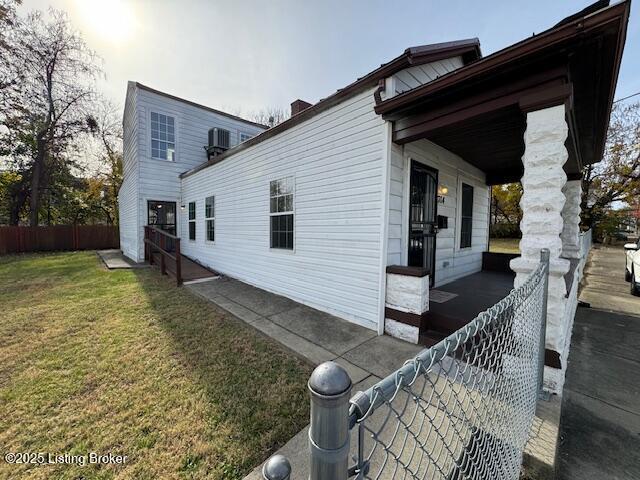 view of home's exterior featuring a yard and fence