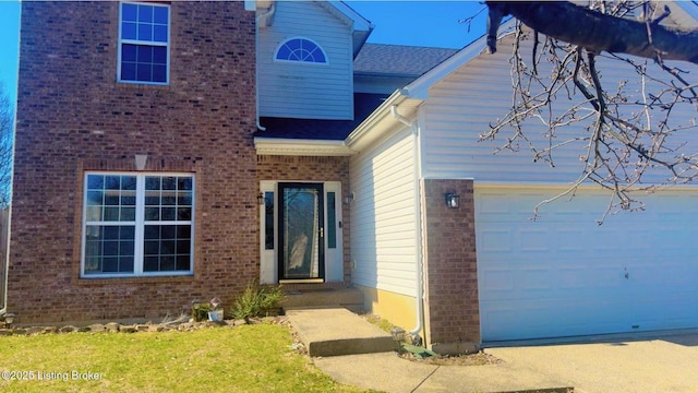 entrance to property with a garage and brick siding