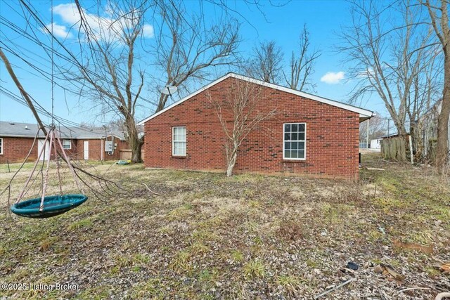 view of side of property featuring brick siding