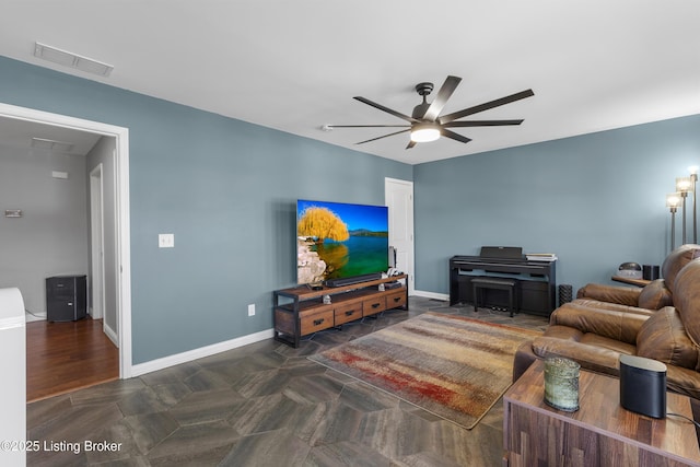 living room with baseboards, visible vents, and ceiling fan