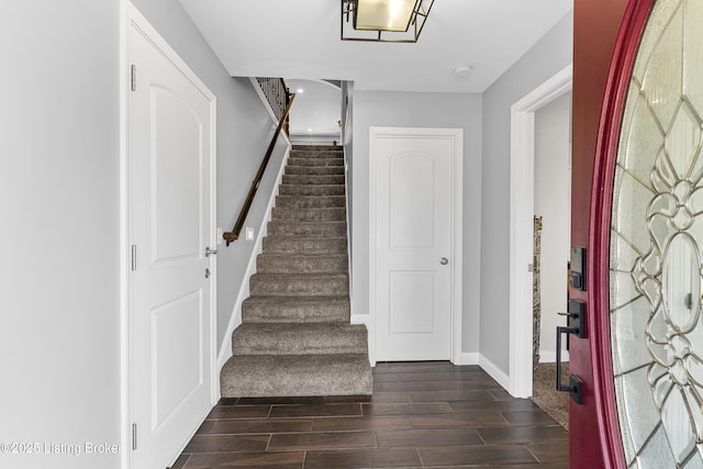 stairs featuring wood finish floors and baseboards