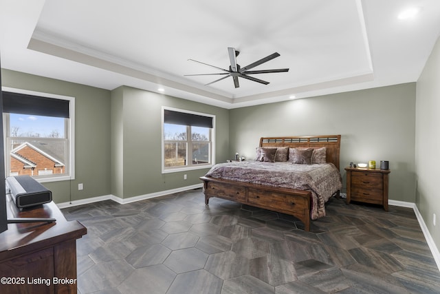 bedroom with recessed lighting, a tray ceiling, and baseboards