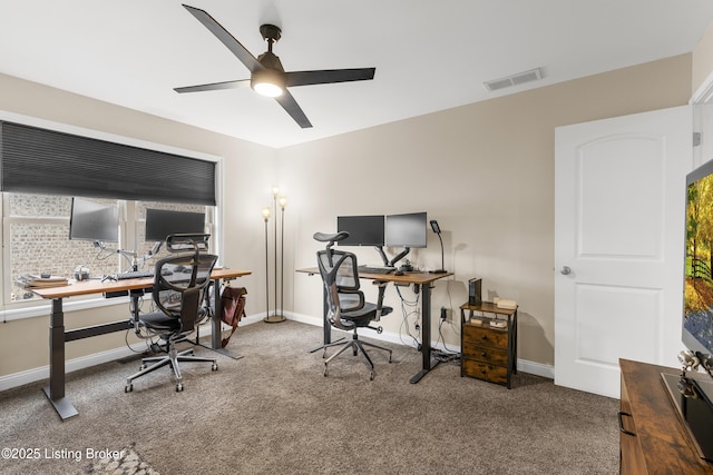 carpeted home office featuring visible vents, baseboards, and a ceiling fan