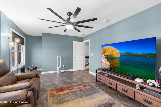 living room with visible vents, baseboards, and ceiling fan