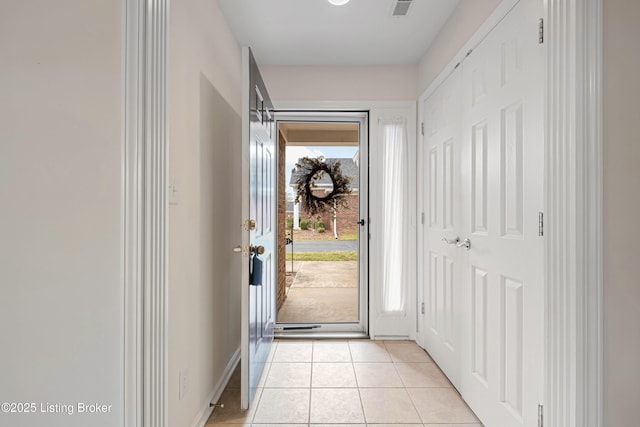 entryway with light tile patterned floors