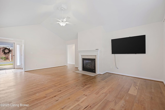 unfurnished living room with light wood-style flooring, a fireplace, baseboards, and ceiling fan