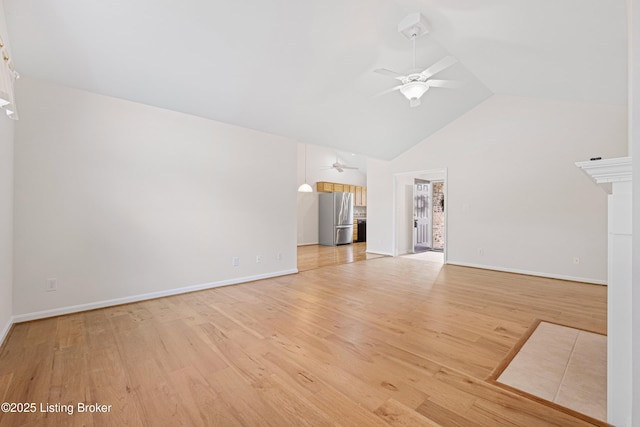 unfurnished living room with light wood finished floors, baseboards, high vaulted ceiling, and ceiling fan