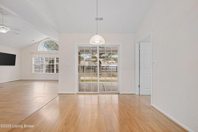 unfurnished dining area featuring baseboards, lofted ceiling, light wood-style floors, and ceiling fan