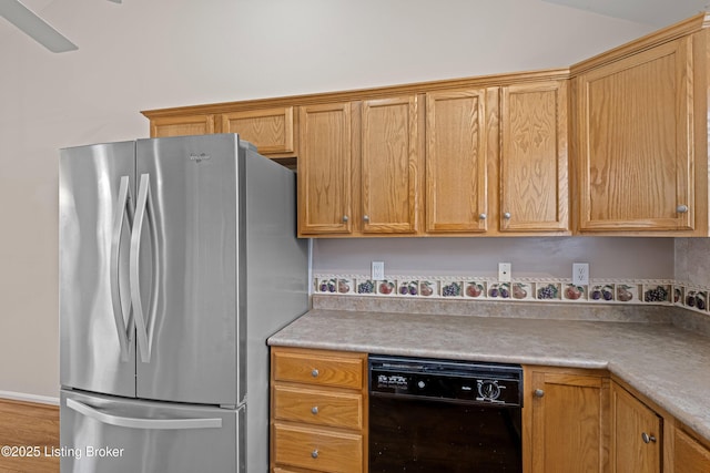 kitchen with light countertops, freestanding refrigerator, and black dishwasher