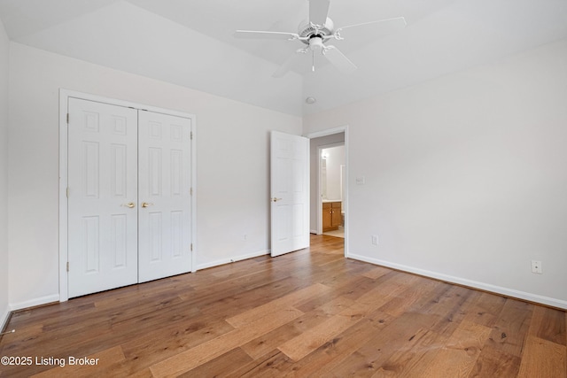 unfurnished bedroom with baseboards and hardwood / wood-style floors