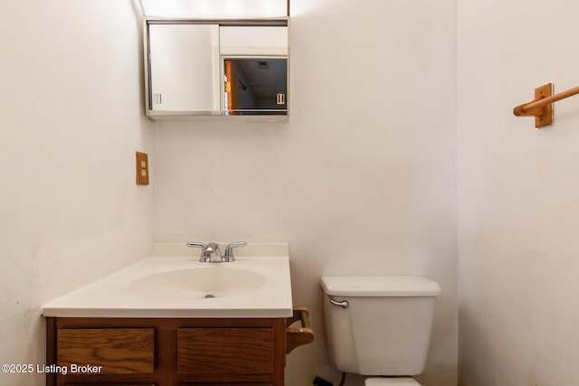 half bathroom featuring toilet and vanity