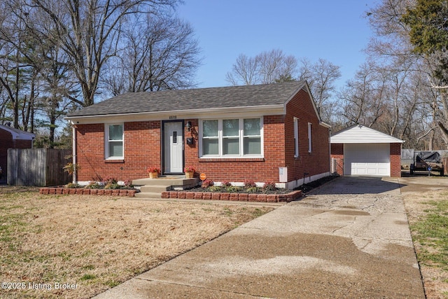 view of front facade with brick siding, an outbuilding, driveway, and fence