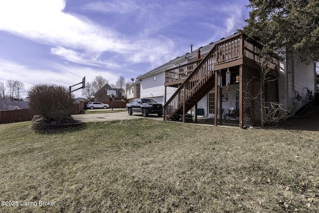 exterior space with a yard, stairway, and a deck