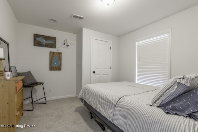 bedroom with visible vents, baseboards, and light carpet