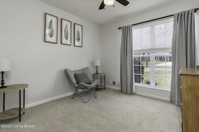 sitting room featuring visible vents, carpet flooring, baseboards, and a healthy amount of sunlight