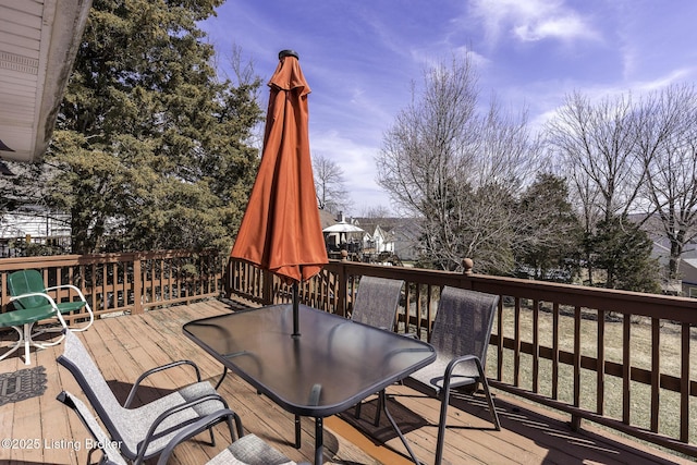 wooden terrace featuring outdoor dining area