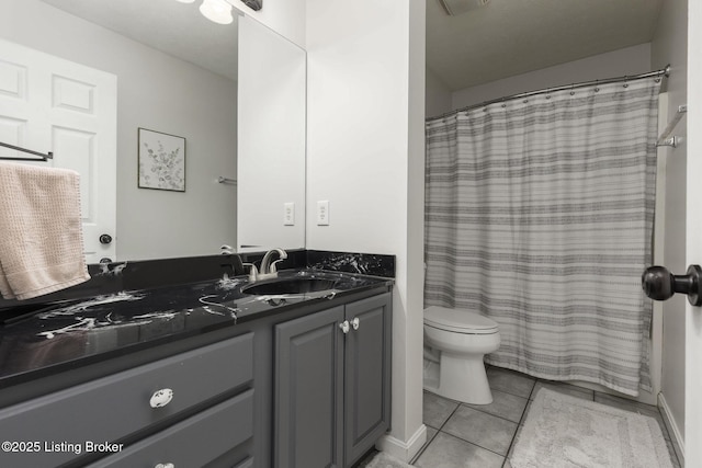 bathroom featuring tile patterned floors, toilet, a shower with shower curtain, and vanity