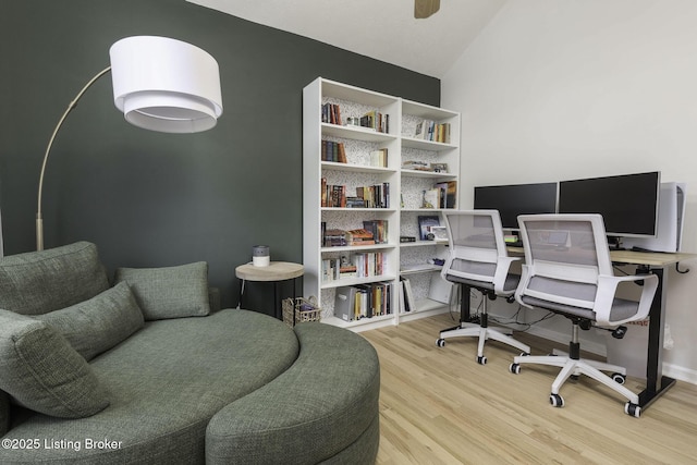 home office featuring lofted ceiling and wood finished floors