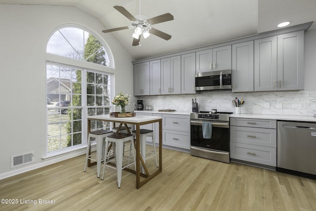 kitchen with light wood-style floors, visible vents, appliances with stainless steel finishes, and gray cabinetry